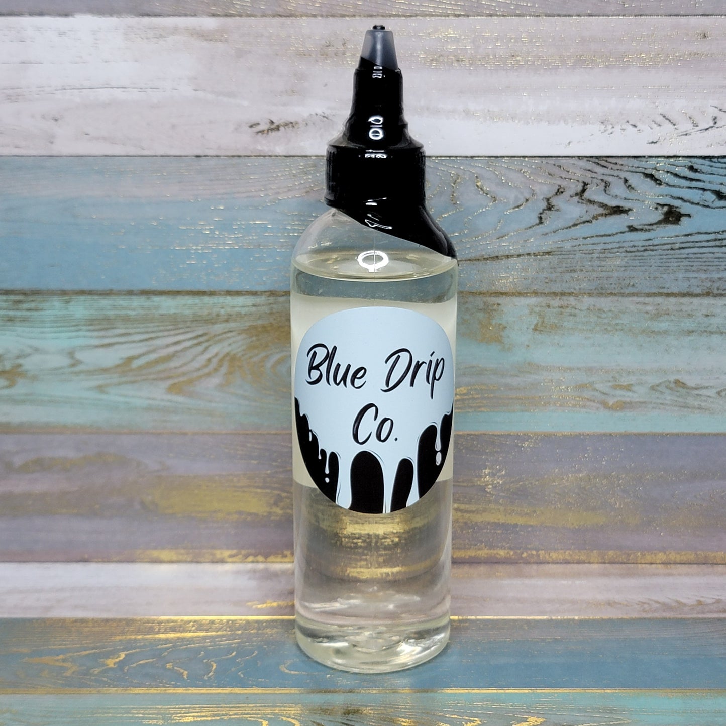 Bottle of Blue Drip Co. liquid on a wooden background