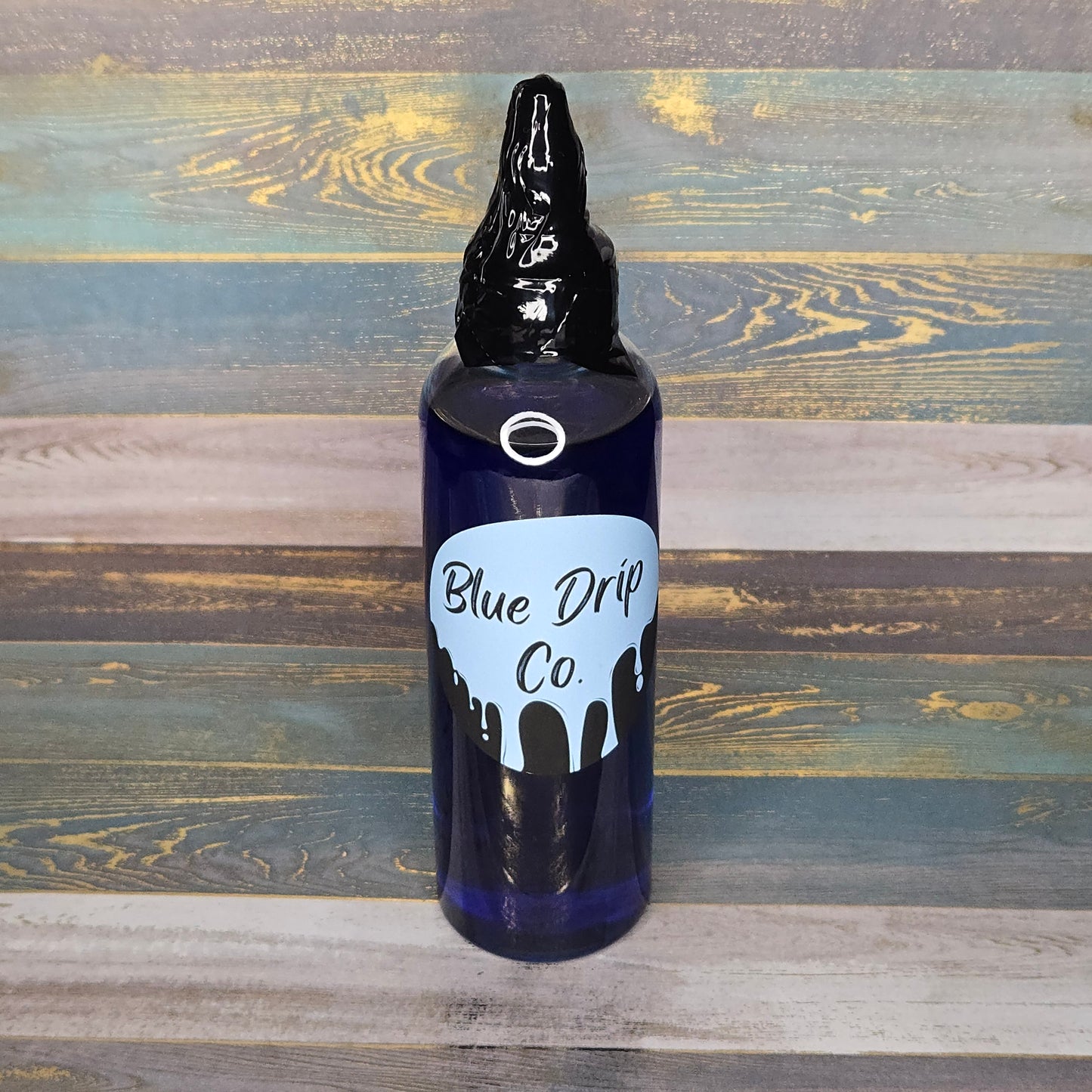 Bottle with a black cap and blue label reading 'Blue Drip Co.'