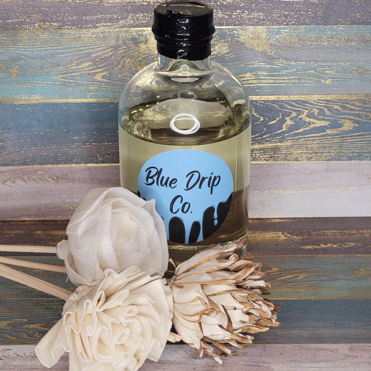 Bottle of Blue Drip Co. with decorative white flowers